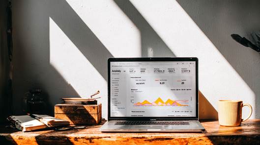 Laptop showing an analytics dashboard on a freelancer's desk